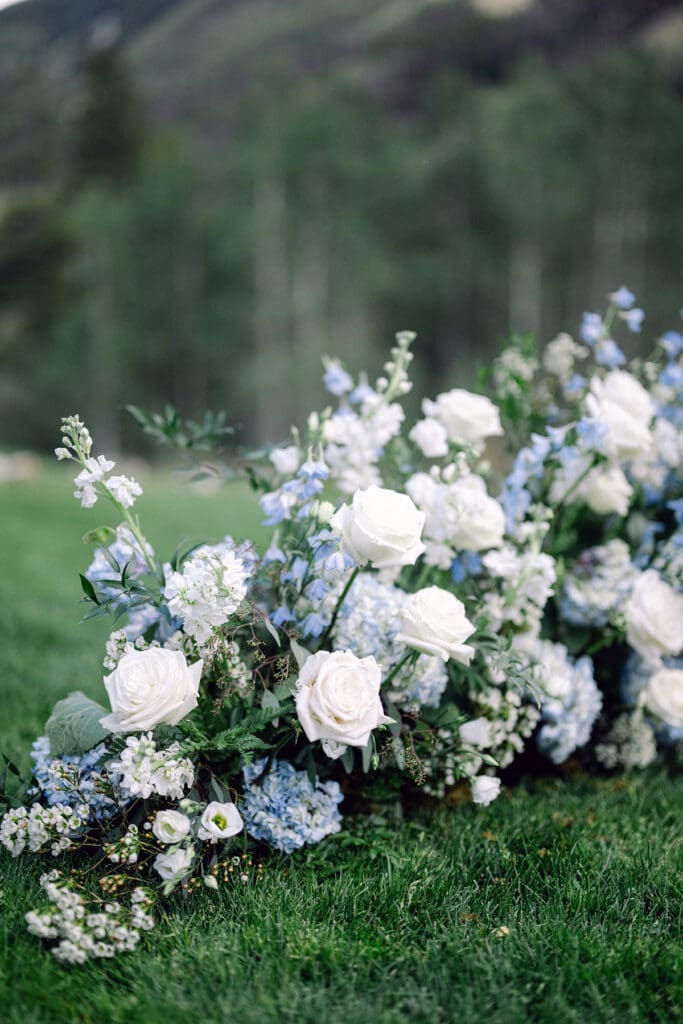 Florist in Vail- Elegant bridal bouquet featuring roses and trailing foliage, captured during a wedding in a natural, alpine landscape.